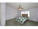 Cozy bedroom with soft carpet, ceiling fan, and serene natural light at 5624 E Garnet Ave, Mesa, AZ 85206