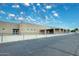 Exterior of a beige building showing fence and parking area at 5624 E Garnet Ave, Mesa, AZ 85206