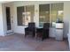 Charming covered patio featuring stone tile, comfortable seating, and convenient mini-fridge at 5624 E Garnet Ave, Mesa, AZ 85206