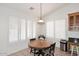 Bright breakfast nook with a round table and white shutters on the windows at 5624 E Garnet Ave, Mesa, AZ 85206