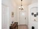 Inviting entryway with decorative lighting, tile flooring, and a view of the front door at 5624 E Garnet Ave, Mesa, AZ 85206