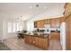 A kitchen and dining nook with center island with granite countertops and lots of light at 5624 E Garnet Ave, Mesa, AZ 85206