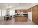 Kitchen area featuring a center island with granite countertops and a breakfast table at 5624 E Garnet Ave, Mesa, AZ 85206
