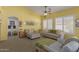 Bright living room with plenty of seating, neutral carpet, large windows, and open floorplan at 5624 E Garnet Ave, Mesa, AZ 85206