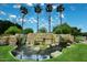 The impressive Stonegate entrance features stone architecture, a tranquil water feature, and manicured landscaping at 5624 E Garnet Ave, Mesa, AZ 85206