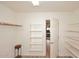 Bright, open walk-in closet providing ample shelving and storage space with access to a bedroom at 5624 E Garnet Ave, Mesa, AZ 85206