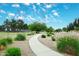 A winding walking path meanders through beautifully landscaped gardens, inviting residents to explore the community at 5624 E Garnet Ave, Mesa, AZ 85206