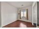 Well-lit bedroom with hardwood floors, a window, and an en-suite bathroom entrance at 5634 N 82 Ave, Glendale, AZ 85303