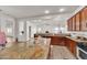 Open kitchen featuring an island, granite countertops, and stainless steel appliances at 5634 N 82 Ave, Glendale, AZ 85303