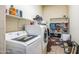 Functional laundry room with modern Samsung washer and dryer, shelves, and ample storage space at 5634 N 82 Ave, Glendale, AZ 85303