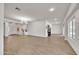 Open-concept living room with hardwood floors, ample natural light, and modern chandelier at 5634 N 82 Ave, Glendale, AZ 85303