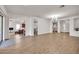 Spacious living room featuring hardwood floors and an open floor plan leading to the kitchen at 5634 N 82 Ave, Glendale, AZ 85303