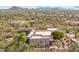 Expansive aerial view of a desert home surrounded by lush greenery, with mountains in the distance at 6432 E Old Paint Trl, Carefree, AZ 85377