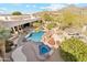 Aerial view of an outdoor pool with a slide, sun loungers, and desert landscaping at 6432 E Old Paint Trl, Carefree, AZ 85377