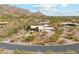 Aerial view of home with desert landscaping, tile roof, and circular drive at 6432 E Old Paint Trl, Carefree, AZ 85377