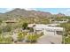 Aerial view of home with desert landscaping and mountain backdrop at 6432 E Old Paint Trl, Carefree, AZ 85377