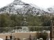 Backyard view with fresh snow, a metal fence, landscaping, and desert vegetation at 6432 E Old Paint Trl, Carefree, AZ 85377