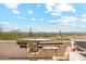 Outdoor balcony with seating offering expansive desert views under a blue sky at 6432 E Old Paint Trl, Carefree, AZ 85377