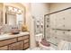 Stylish bathroom featuring a copper sink, stone countertop, and a tiled shower with glass door at 6432 E Old Paint Trl, Carefree, AZ 85377