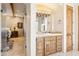 Bright bathroom featuring a granite vanity, rustic wood accents and view to the Primary bedroom at 6432 E Old Paint Trl, Carefree, AZ 85377