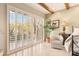 Bright bedroom featuring wooden beams, a chair and outdoor views through shuttered windows at 6432 E Old Paint Trl, Carefree, AZ 85377