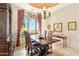 Bright dining room featuring desert views, a decorative ceiling, and elegant chandelier lighting at 6432 E Old Paint Trl, Carefree, AZ 85377