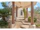 Charming entryway with decorative columns, desert landscaping, and a winding pathway, offering a warm welcome at 6432 E Old Paint Trl, Carefree, AZ 85377