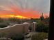 Desert landscaping compliments a colorful sunset through the community gate at 6432 E Old Paint Trl, Carefree, AZ 85377