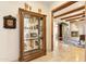 Inviting hallway with display cabinet and decorative fireplace, showcasing the home's elegant design at 6432 E Old Paint Trl, Carefree, AZ 85377