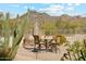 Picturesque outdoor dining area with stylish furniture and a view of the desert landscape at 6432 E Old Paint Trl, Carefree, AZ 85377