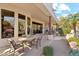 Covered patio features dining and lounge seating, with a fireplace and views of desert landscape at 6432 E Old Paint Trl, Carefree, AZ 85377