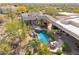 An aerial view of a backyard oasis featuring a luxurious pool, lush landscaping, and an outdoor grill at 6432 E Old Paint Trl, Carefree, AZ 85377