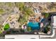 Overhead shot of private pool and desert landscaping featuring a built-in grotto and native vegetation at 6432 E Old Paint Trl, Carefree, AZ 85377