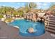 Resort-style pool with waterfall feature and surrounding landscaping at 6432 E Old Paint Trl, Carefree, AZ 85377