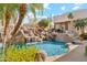 Amazing backyard with a waterfall feature, a pool with rock features, palms, and easy access to the home at 6432 E Old Paint Trl, Carefree, AZ 85377