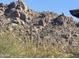 View of a natural rock formation with desert vegetation in the foreground, offering a natural and rugged landscape at 6432 E Old Paint Trl, Carefree, AZ 85377