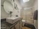 Bathroom with a white vessel sink, granite countertop, framed mirror and a walk-in shower at 650 N Hawes Rd # 2852, Mesa, AZ 85207