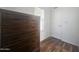 Bedroom featuring a wood-look flooring, a dark wood dresser and a window with blinds at 650 N Hawes Rd # 2852, Mesa, AZ 85207