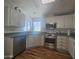 Bright kitchen features stainless steel appliances, granite countertops, and white cabinets at 650 N Hawes Rd # 2852, Mesa, AZ 85207