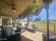 Covered patio area with a ceiling fan and outdoor furniture overlooking the golf course at 650 N Hawes Rd # 2852, Mesa, AZ 85207