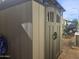 Durable outdoor shed for extra storage, featuring an attractive design and easy access on a tiled path at 650 N Hawes Rd # 2852, Mesa, AZ 85207