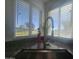 Close up of kitchen sink, granite countertop, and window overlooking the yard at 650 N Hawes Rd # 2852, Mesa, AZ 85207