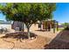 Backyard view of patio with grill, grass area, and orange tree at 6543 E Preston St, Mesa, AZ 85215