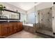 Elegant bathroom featuring a large mirror, soaking tub, glass enclosed shower, and tasteful fixtures at 6543 E Preston St, Mesa, AZ 85215