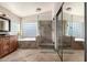 Luxurious bathroom with dual vanity, soaking tub, walk-in shower, and ample natural light at 6543 E Preston St, Mesa, AZ 85215