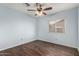 Bright bedroom with wood flooring, a ceiling fan, and a window that provides natural light at 6543 E Preston St, Mesa, AZ 85215