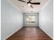 Comfortable bedroom with wood flooring, a ceiling fan, and a window offering ample natural light at 6543 E Preston St, Mesa, AZ 85215