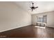 Spacious room featuring dark wood floors, neutral walls and a ceiling fan for optimal comfort at 6543 E Preston St, Mesa, AZ 85215