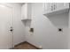 Bright laundry room with white cabinets and tile flooring at 6543 E Preston St, Mesa, AZ 85215