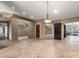 Spacious living room featuring tile floors and modern lighting fixtures with view to exterior patio at 6543 E Preston St, Mesa, AZ 85215